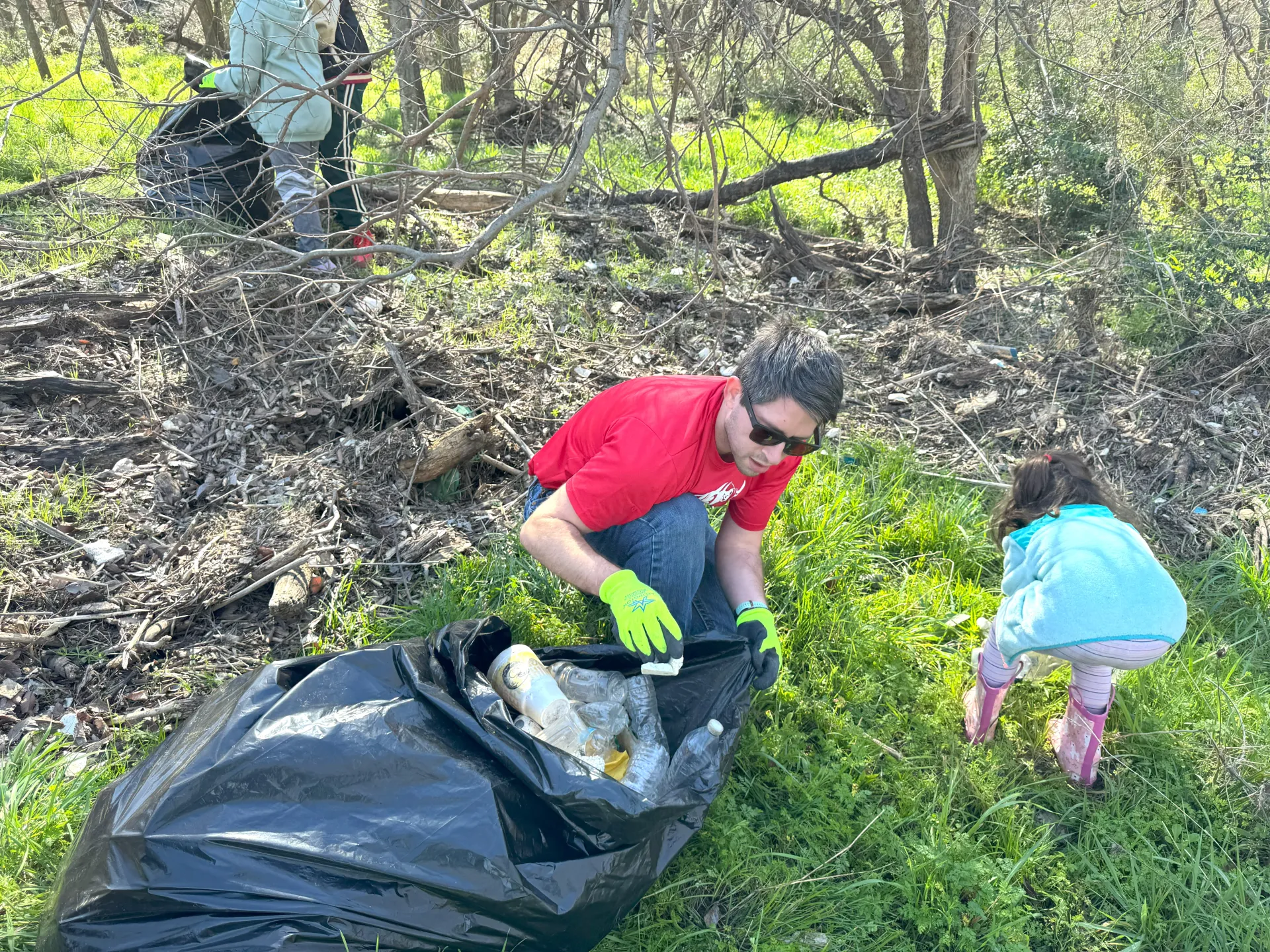 two people picking up trash